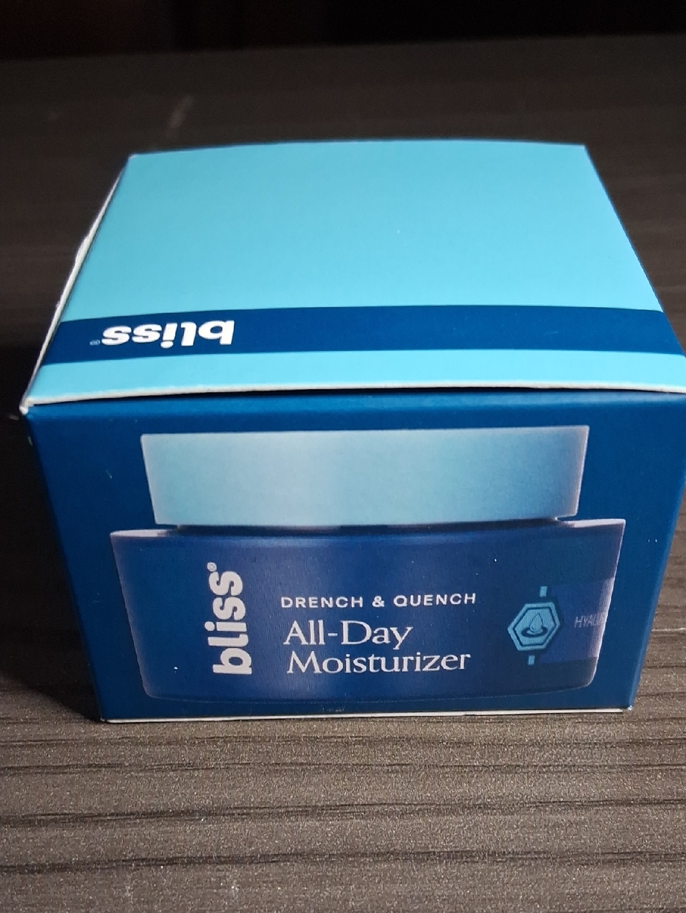 Bliss All-Day Moisturizer in light blue and deep blue packaging